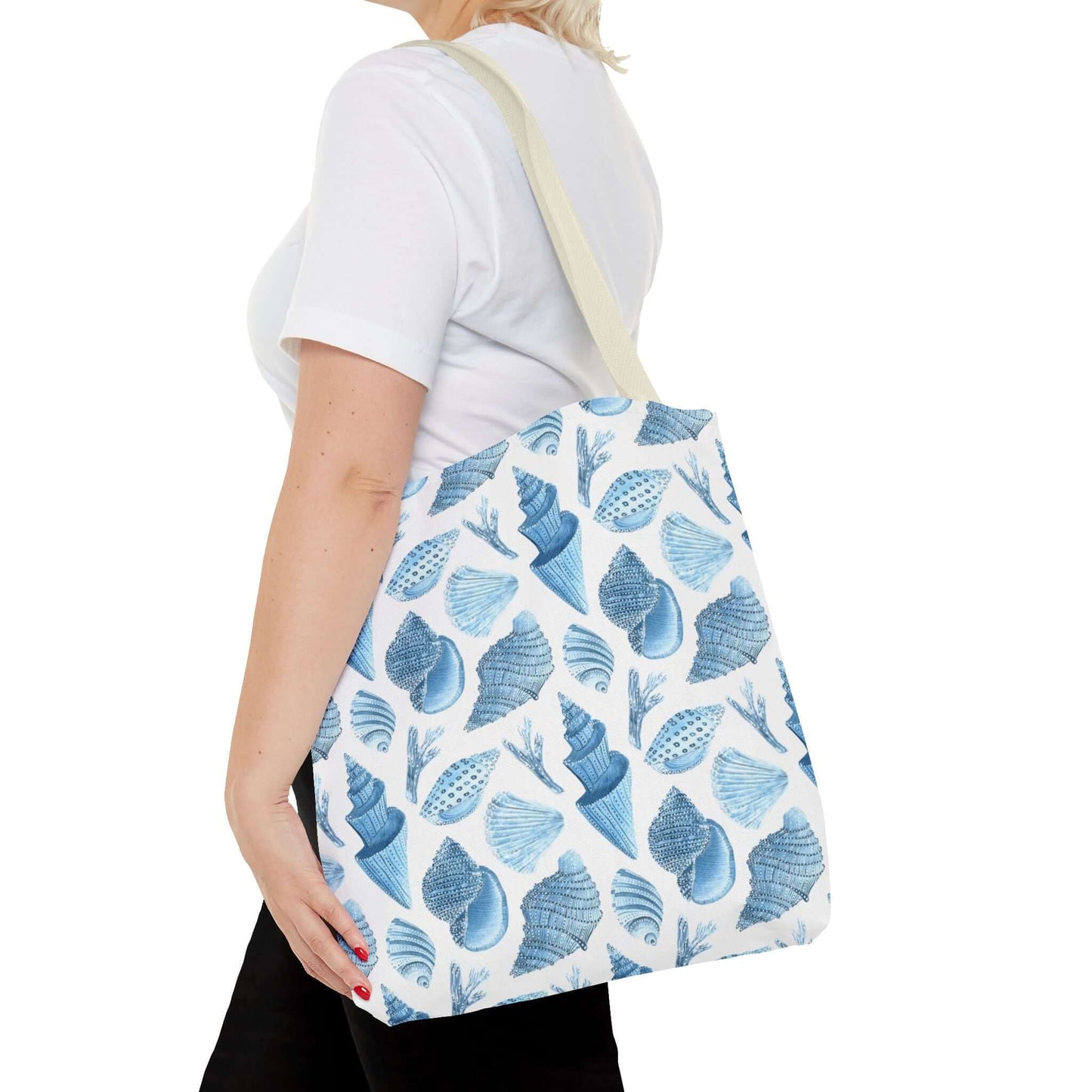 Woman carrying a Beachy Tote Bag with ocean seashells print, perfect for eco-friendly style.