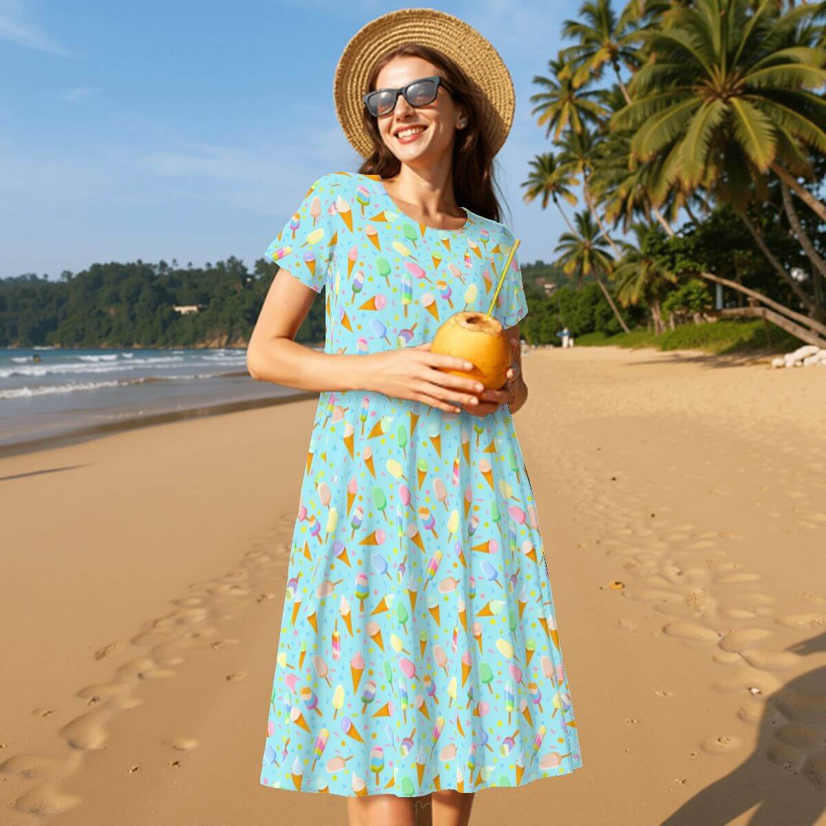 Model wearing a mint ice cream t-shirt dress on the beach, perfect for summer fun and relaxation.