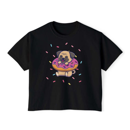 Playful pug on a donut with sprinkles, featured on a boxy black women’s tee shirt, perfect for dog lovers.