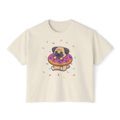Playful pug graphic on a cream boxy tee, munching a donut with colorful sprinkles, perfect for dog lovers.