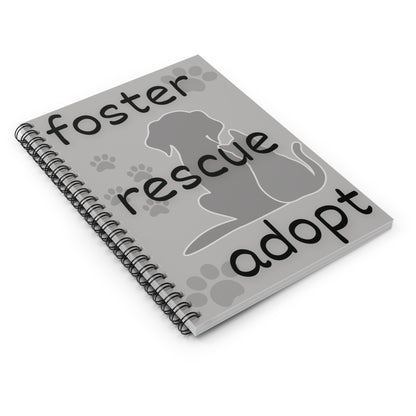 laid down gray spiral notebook with dog and cat image and the words foster, rescue, adopt on the front