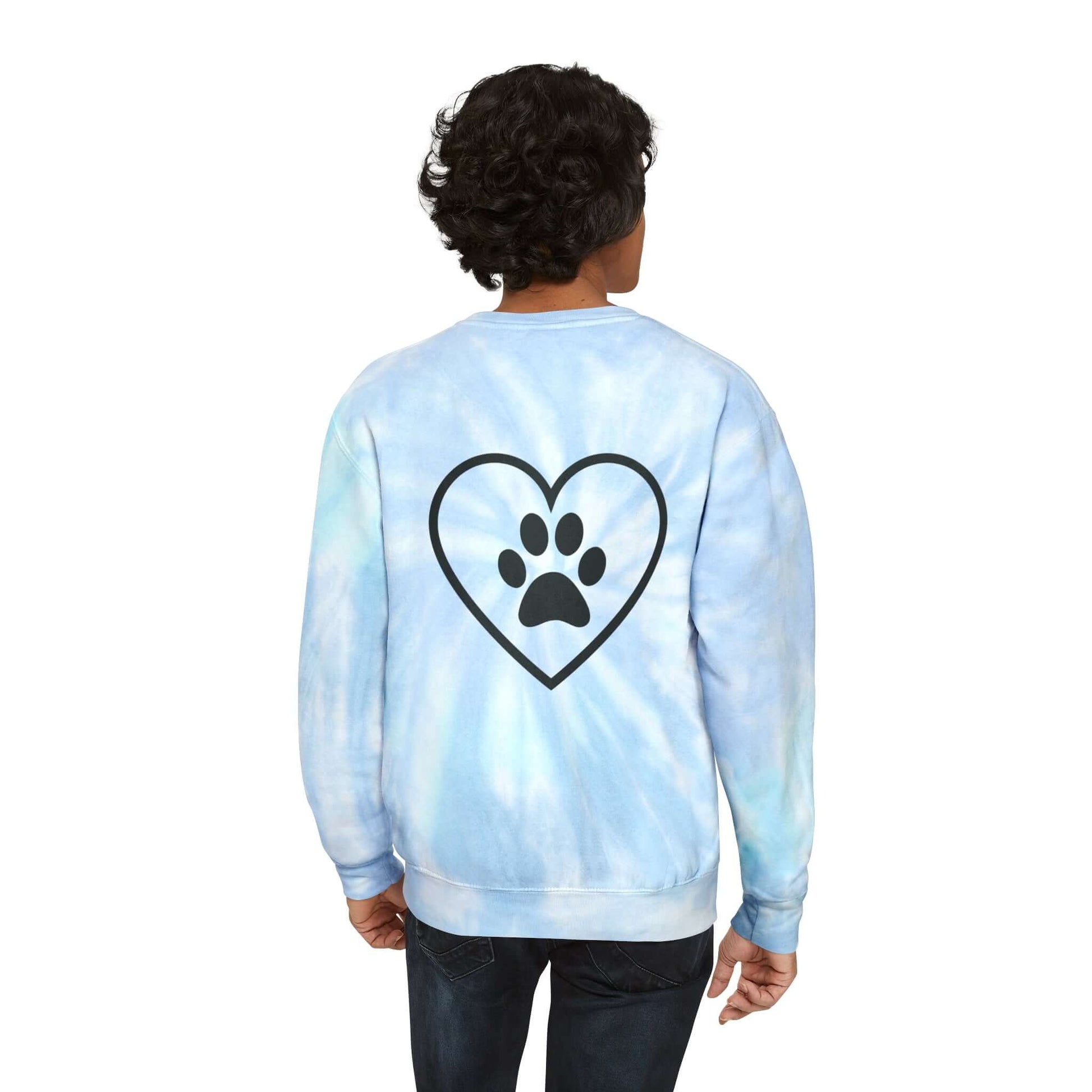 Dark Skinned Young Man Wearing Light Blue (Lagoon) Tie Dye Sweatshirt showing the back which has a full back design featuring an outline of a heart with a black paw in the center of it. 