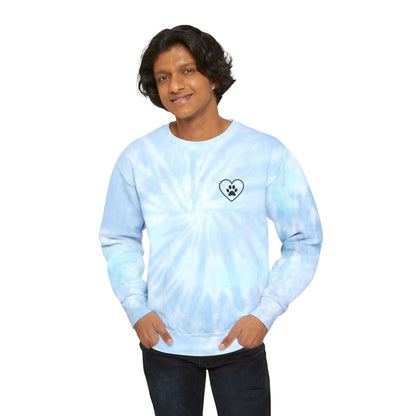 Dark Skinned Young Man Wearing Light Blue (Lagoon) Tie Dye Sweatshirt showing the front which has a chest design featuring an outline of a heart with a black paw in the center of it. 