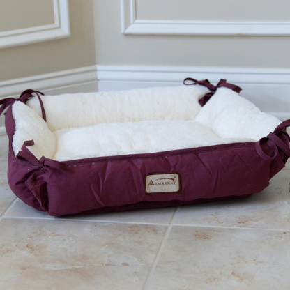 plush burgundy cat bed with sides tied on tile floor in the corner