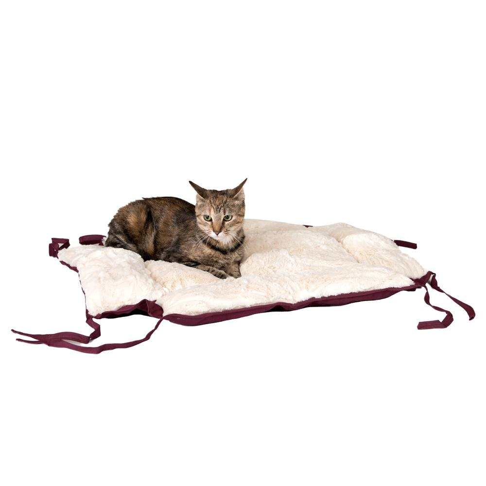 plush burgundy cat bed untied and a tabby cat laying on top of it