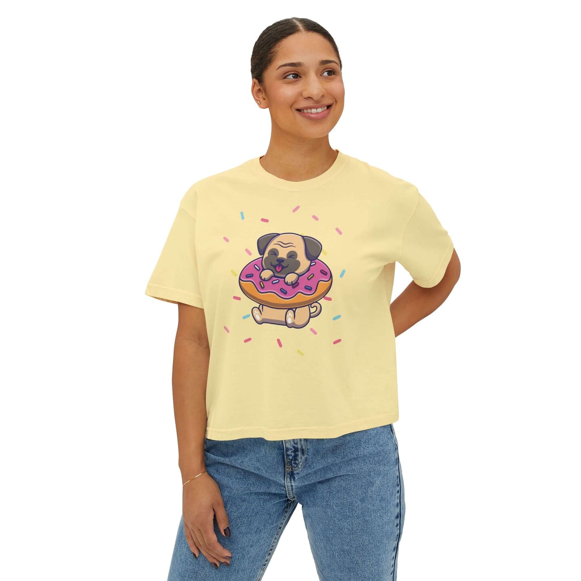 Playful pug graphic on a yellow women's boxy tee, featuring sprinkles and a donut, perfect for dog lovers.