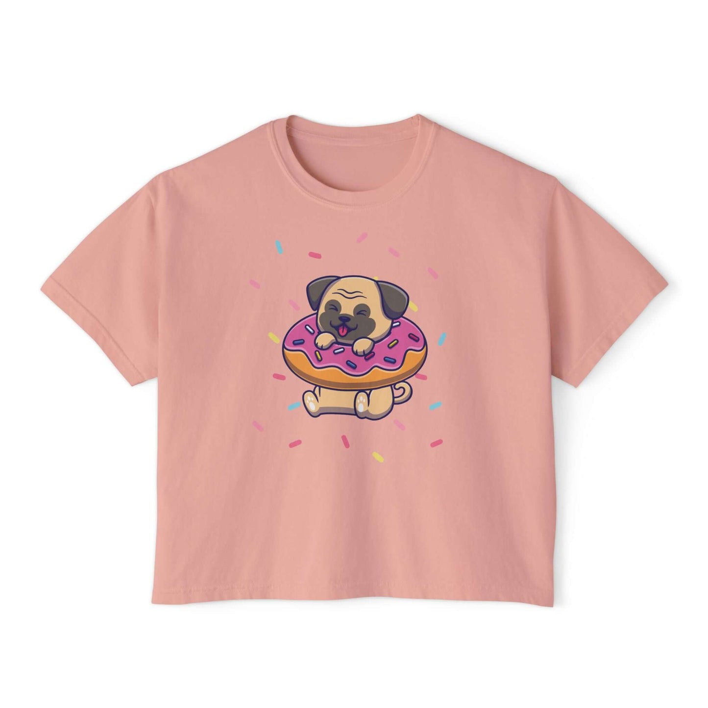 Playful pug graphic on pink boxy tee, featuring a pug with donut and sprinkles, perfect for dog lovers.