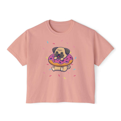 Playful pug graphic on pink boxy tee, featuring a pug with donut and sprinkles, perfect for dog lovers.