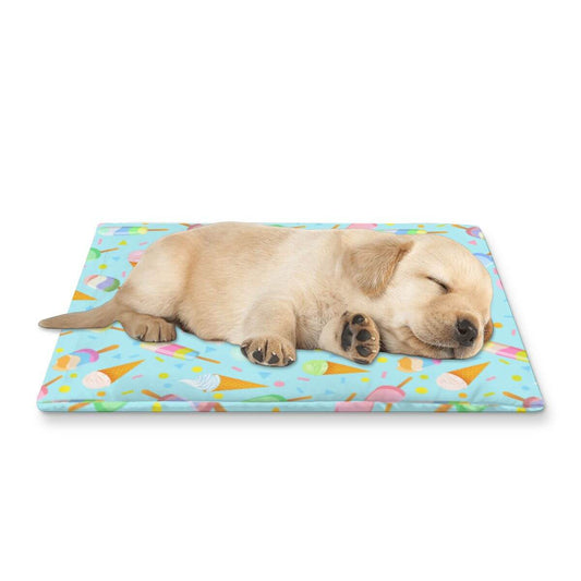 Sleeping puppy on mint green cooling mat with ice cream pattern, perfect for keeping pets cool in summer.